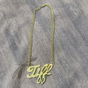 Gold toned Tiff Necklace with Script Tiff Pendant (faux gold).